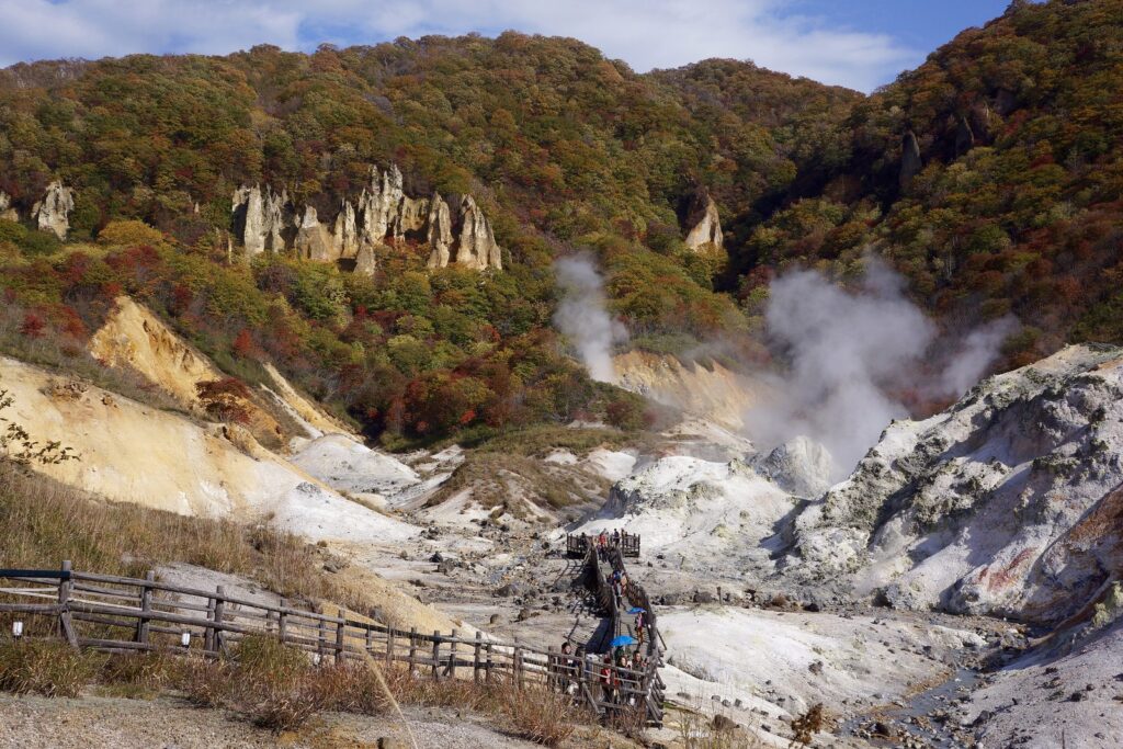 白い岩肌のあちこちから噴気が立ち上る登別地獄谷と遊歩道